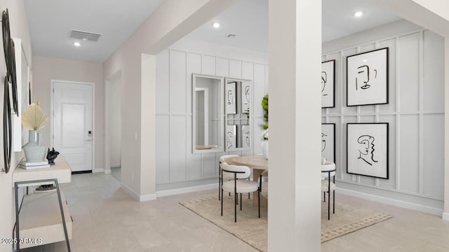 dining area featuring baseboards, visible vents, a decorative wall, and recessed lighting