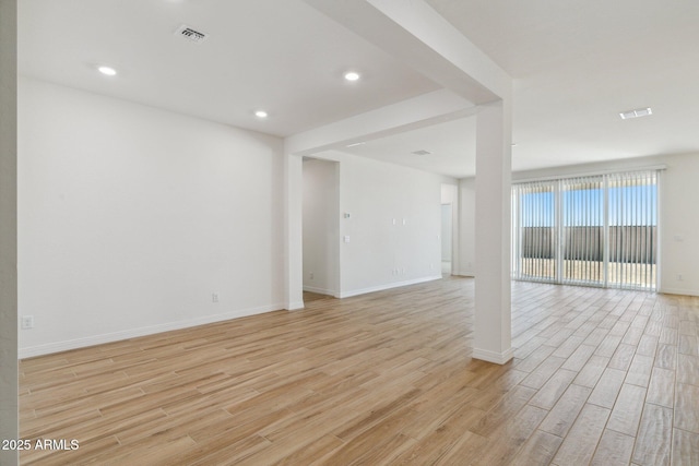 spare room with light wood finished floors, baseboards, visible vents, and recessed lighting