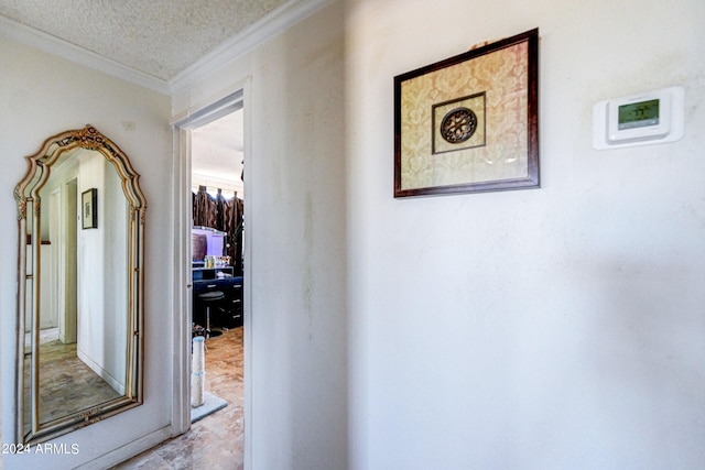 hallway featuring a textured ceiling and ornamental molding