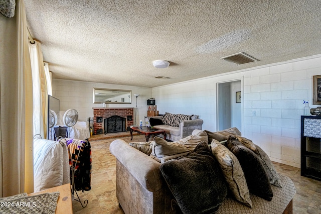 living room featuring a textured ceiling and a brick fireplace