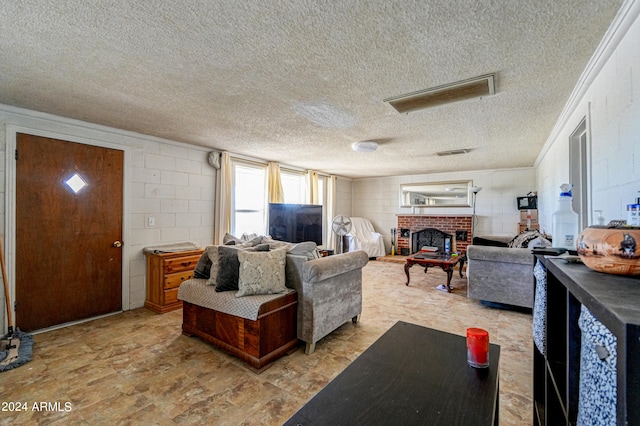 living room with ornamental molding, a textured ceiling, and a brick fireplace