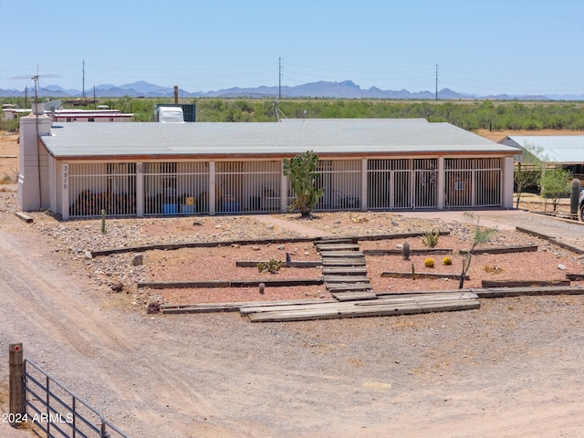 view of front of house with a mountain view and an outbuilding