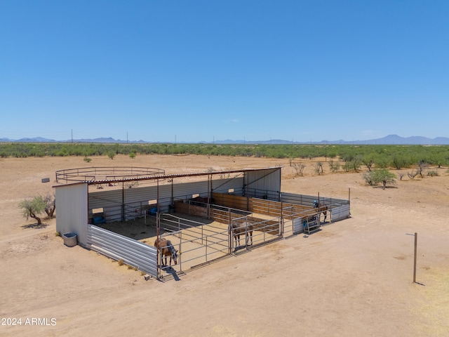 view of horse barn with a rural view