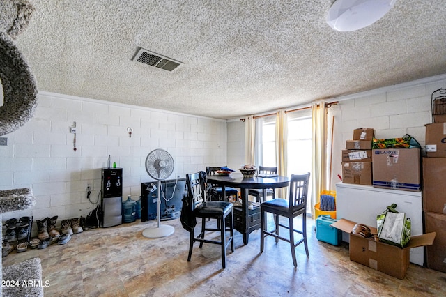 dining space with a textured ceiling