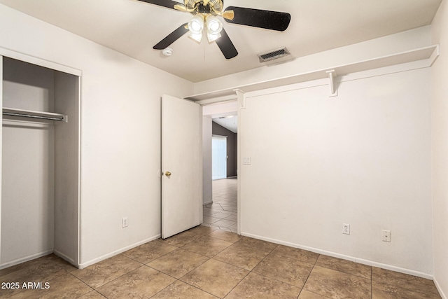 3006 W Matthew Dr, Phoenix, AZ 85027 - unfurnished bedroom featuring a closet, baseboards, light tile patterned floors, and ceiling fan