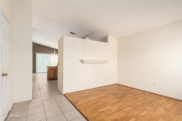 3006 W Matthew Dr, Phoenix, AZ 85027 - empty room with lofted ceiling, a chandelier, light wood finished floors, and track lighting
