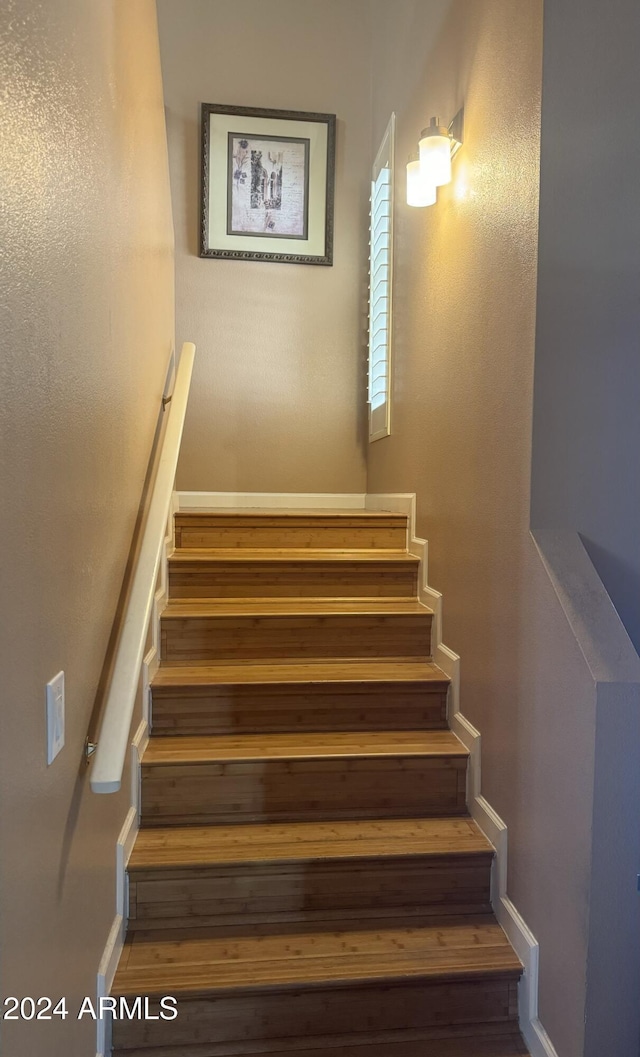 staircase featuring hardwood / wood-style flooring