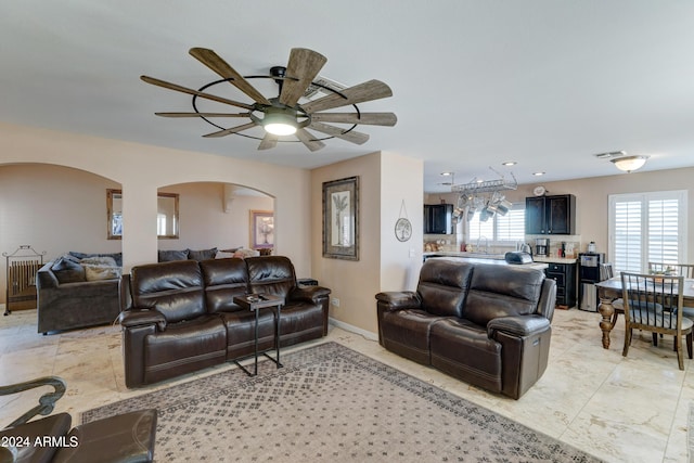 living room featuring ceiling fan and sink