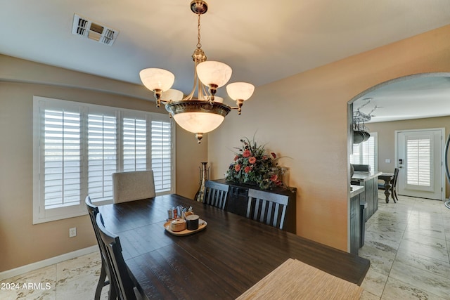 dining area featuring an inviting chandelier