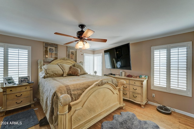 bedroom featuring light hardwood / wood-style floors, multiple windows, and ceiling fan