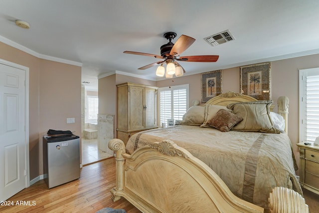 bedroom featuring connected bathroom, ceiling fan, refrigerator, light wood-type flooring, and ornamental molding