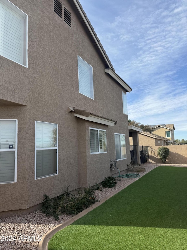 view of side of home featuring a lawn