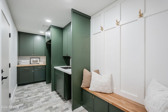 mudroom featuring visible vents, a sink, and recessed lighting