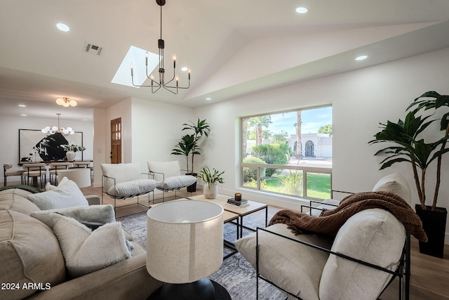 living area featuring lofted ceiling, recessed lighting, a notable chandelier, wood finished floors, and visible vents