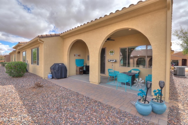 view of patio / terrace featuring grilling area, central AC unit, and a ceiling fan