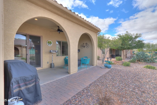 view of patio featuring a grill and a ceiling fan