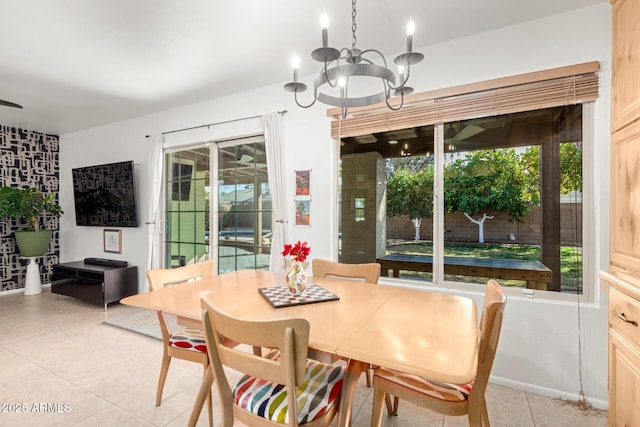 dining space with a healthy amount of sunlight, light tile patterned floors, and a chandelier