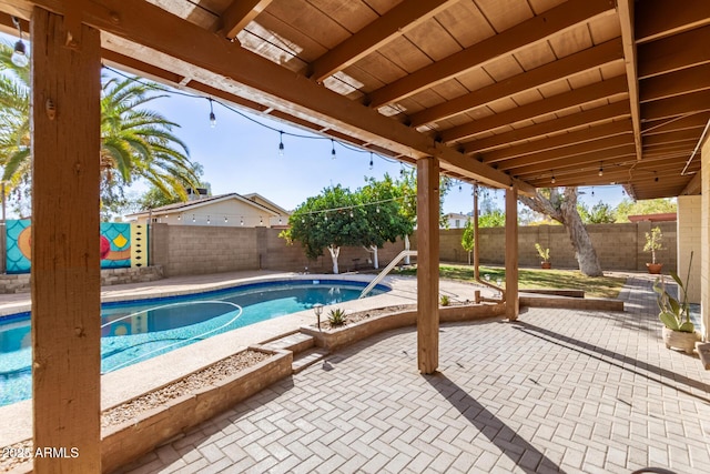 view of pool featuring a patio, a fenced backyard, and a fenced in pool