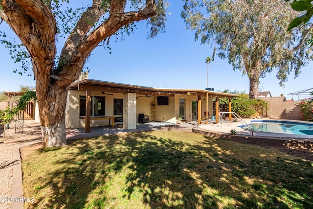 rear view of house featuring a yard, a patio area, a fenced backyard, and a ceiling fan