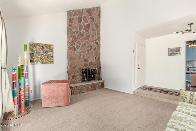 carpeted living room with high vaulted ceiling and a fireplace