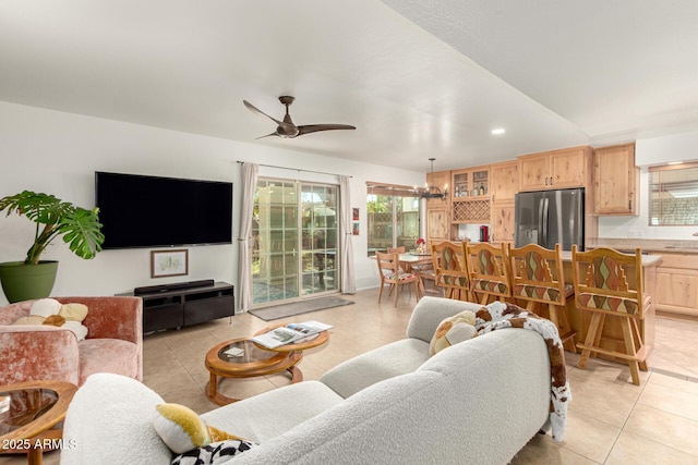 living area featuring ceiling fan, light tile patterned floors, a wealth of natural light, and recessed lighting