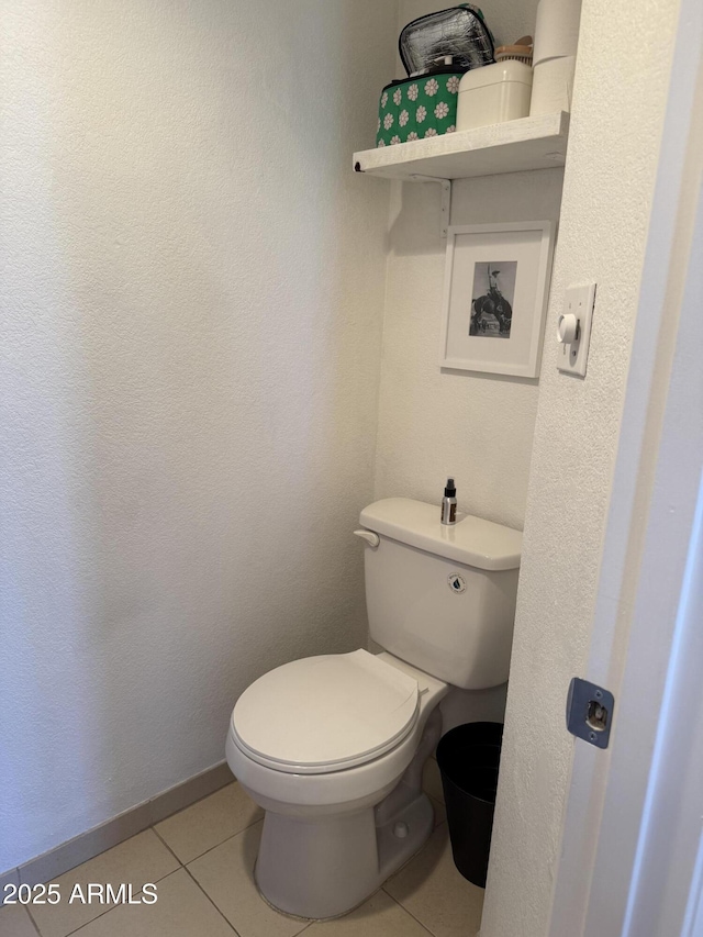 bathroom featuring toilet and tile patterned floors