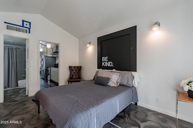 bedroom featuring lofted ceiling and connected bathroom