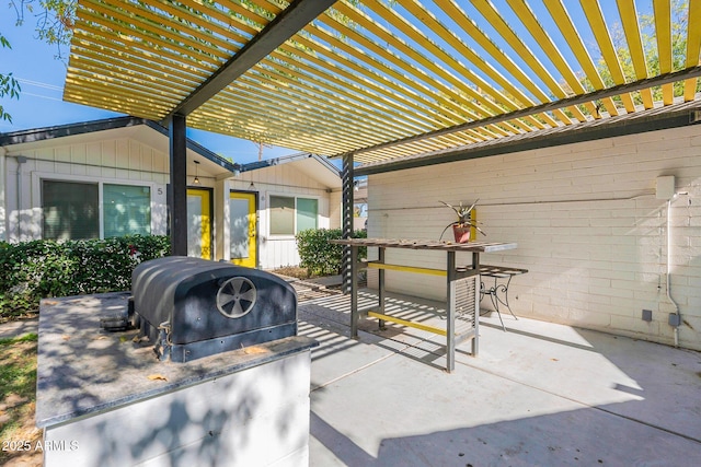 view of patio featuring an outdoor kitchen, area for grilling, and a pergola