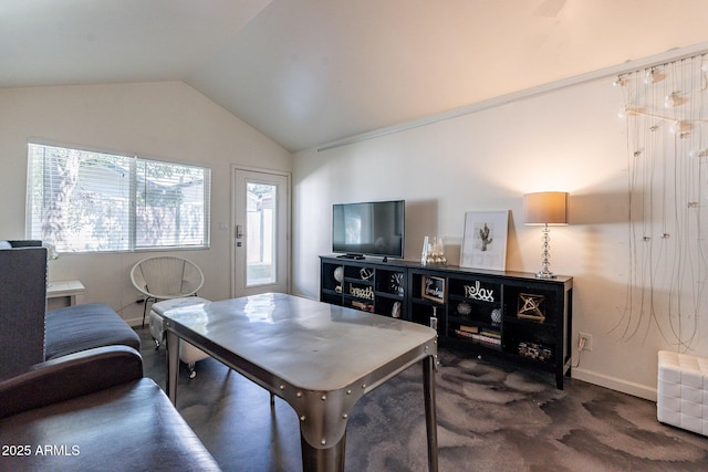 dining space with dark colored carpet and lofted ceiling