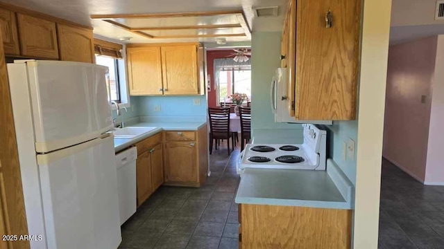 kitchen featuring light brown cabinets, white appliances, and sink