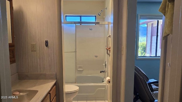 full bathroom featuring tile patterned floors, vanity, enclosed tub / shower combo, and toilet