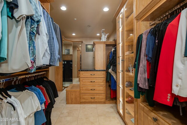 walk in closet with light tile patterned floors