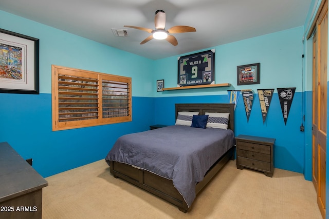 bedroom with ceiling fan and light carpet