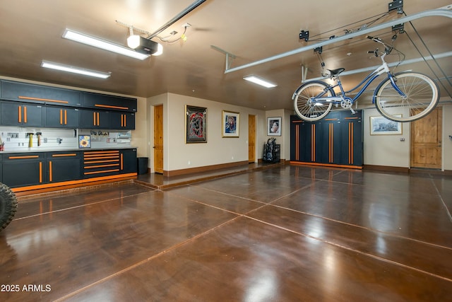 garage with a workshop area and a garage door opener