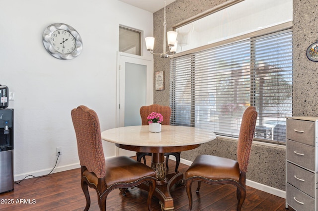 dining space featuring baseboards, wood finished floors, and a healthy amount of sunlight