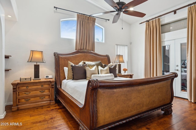 bedroom featuring wood-type flooring, vaulted ceiling, french doors, and ceiling fan