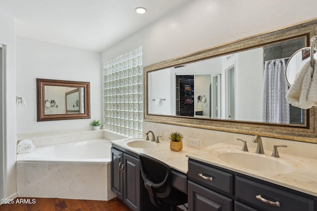 full bathroom with plenty of natural light, a sink, and double vanity