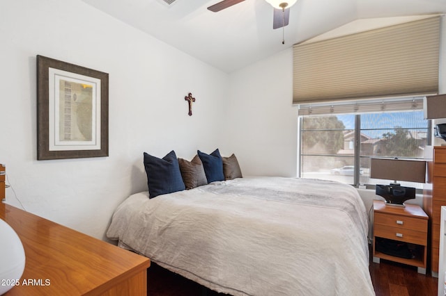 bedroom with lofted ceiling, wood finished floors, and a ceiling fan