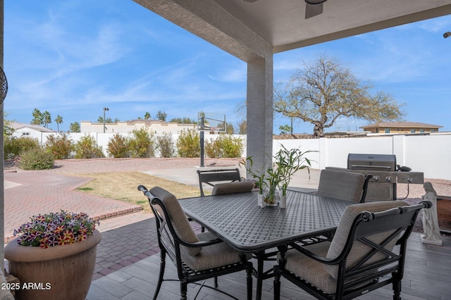 view of patio / terrace featuring a ceiling fan, outdoor dining space, and a fenced backyard