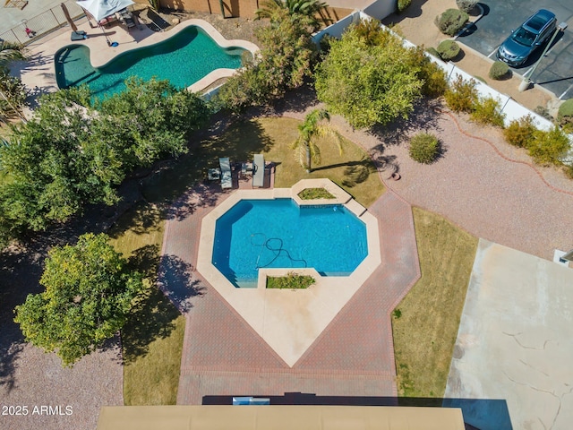 outdoor pool with fence private yard and a patio area