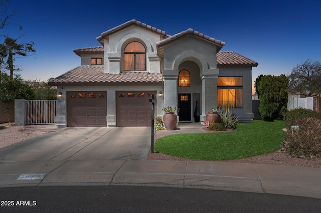 mediterranean / spanish home featuring concrete driveway, a tile roof, fence, and stucco siding