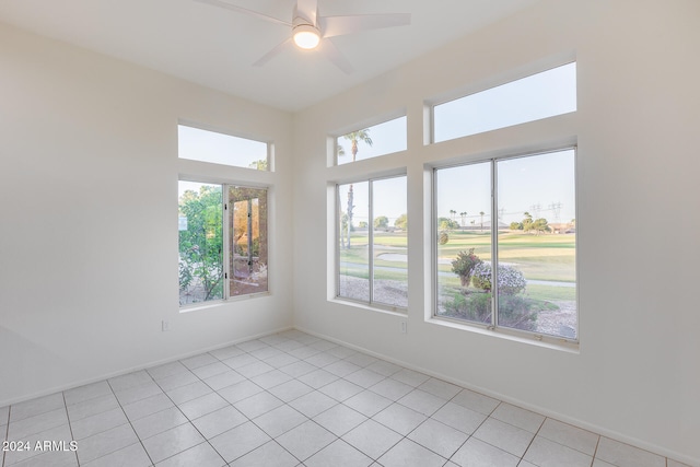 empty room featuring ceiling fan and light tile patterned flooring