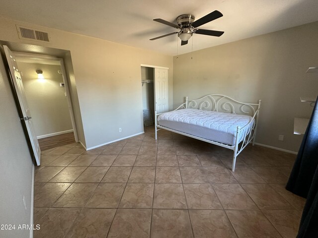 bedroom with ceiling fan and a closet