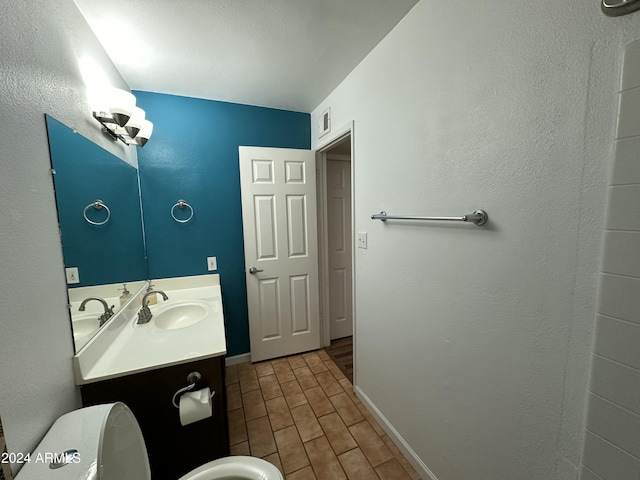 bathroom with hardwood / wood-style flooring, vanity, and toilet