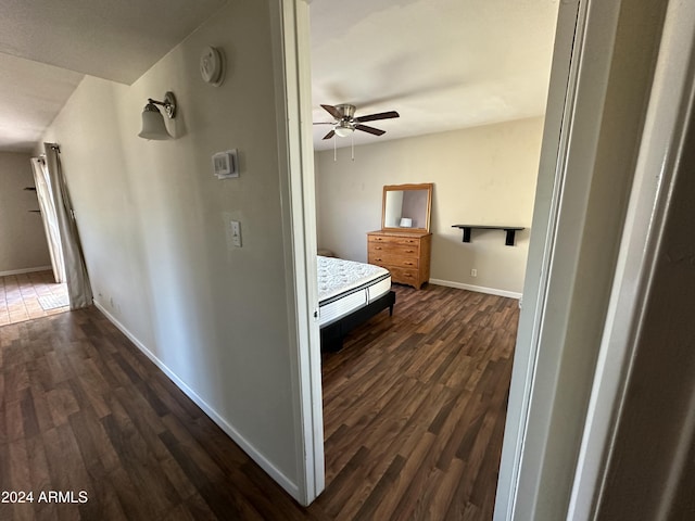 corridor with dark hardwood / wood-style flooring