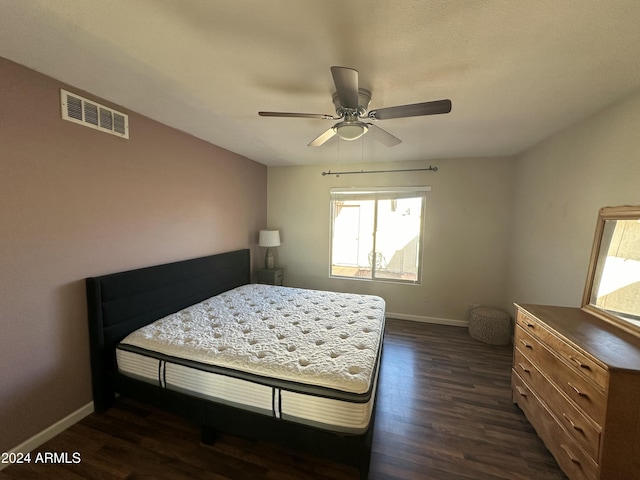 bedroom featuring ceiling fan and dark wood-type flooring