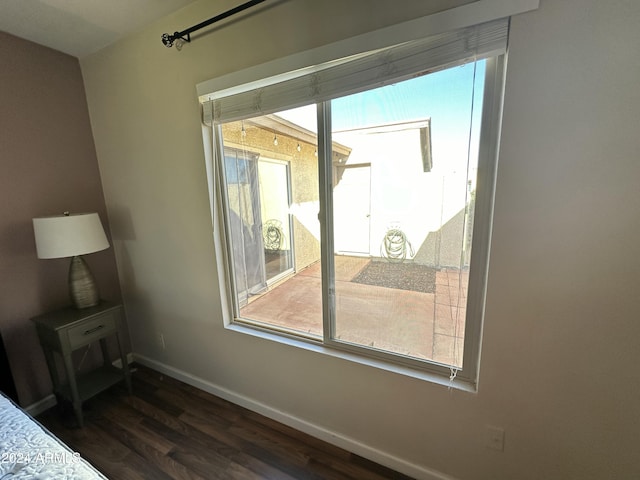 bedroom with dark hardwood / wood-style floors