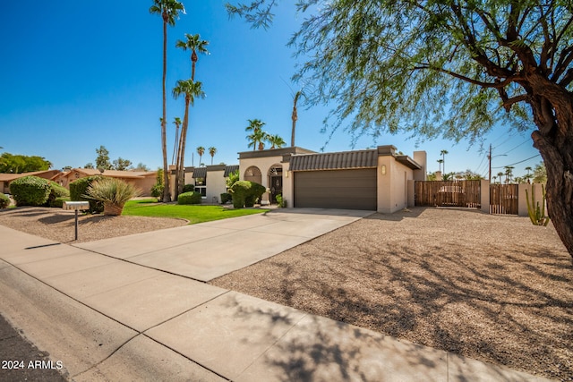 view of front of property featuring a garage and a front lawn