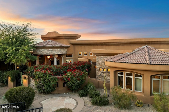 back house at dusk with a patio