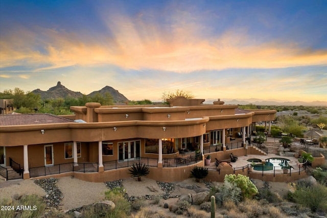 back house at dusk with a mountain view